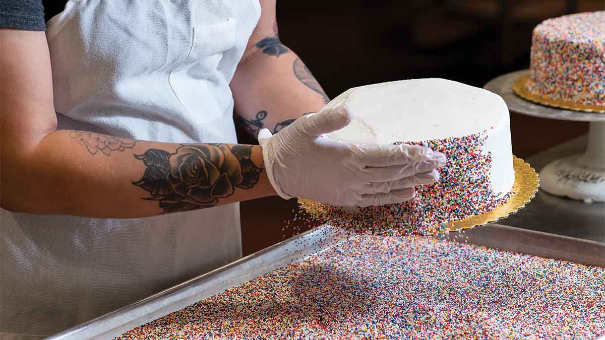 Nugget Markets associates decorating cake