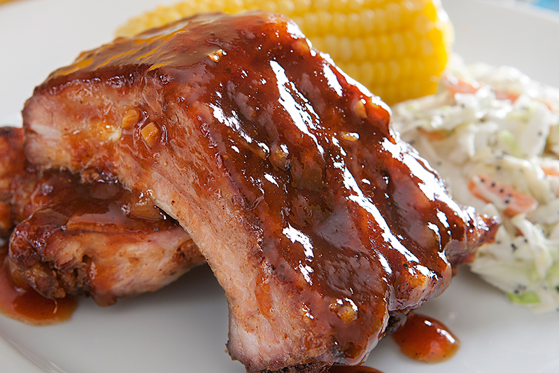 pork baby back ribs with coleslaw and corn on the cob