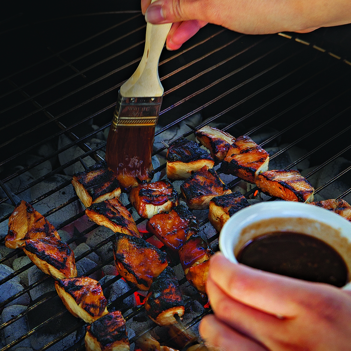 skewers on grill with sauce