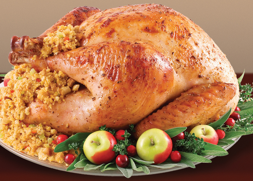 Whole cooked turkey with stuffing and apples