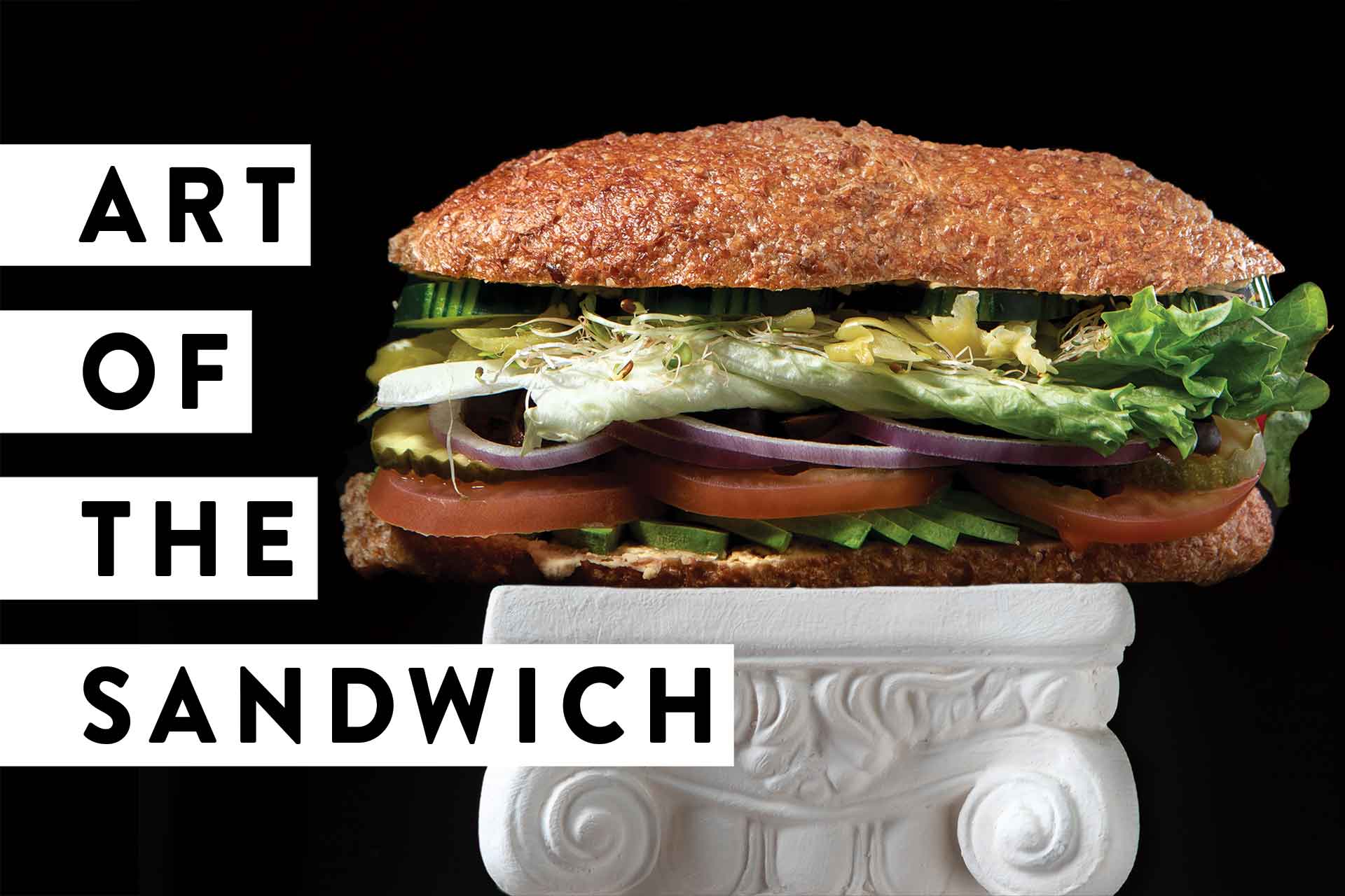 Art of the Sandwich text with a sandwich on a pedistal