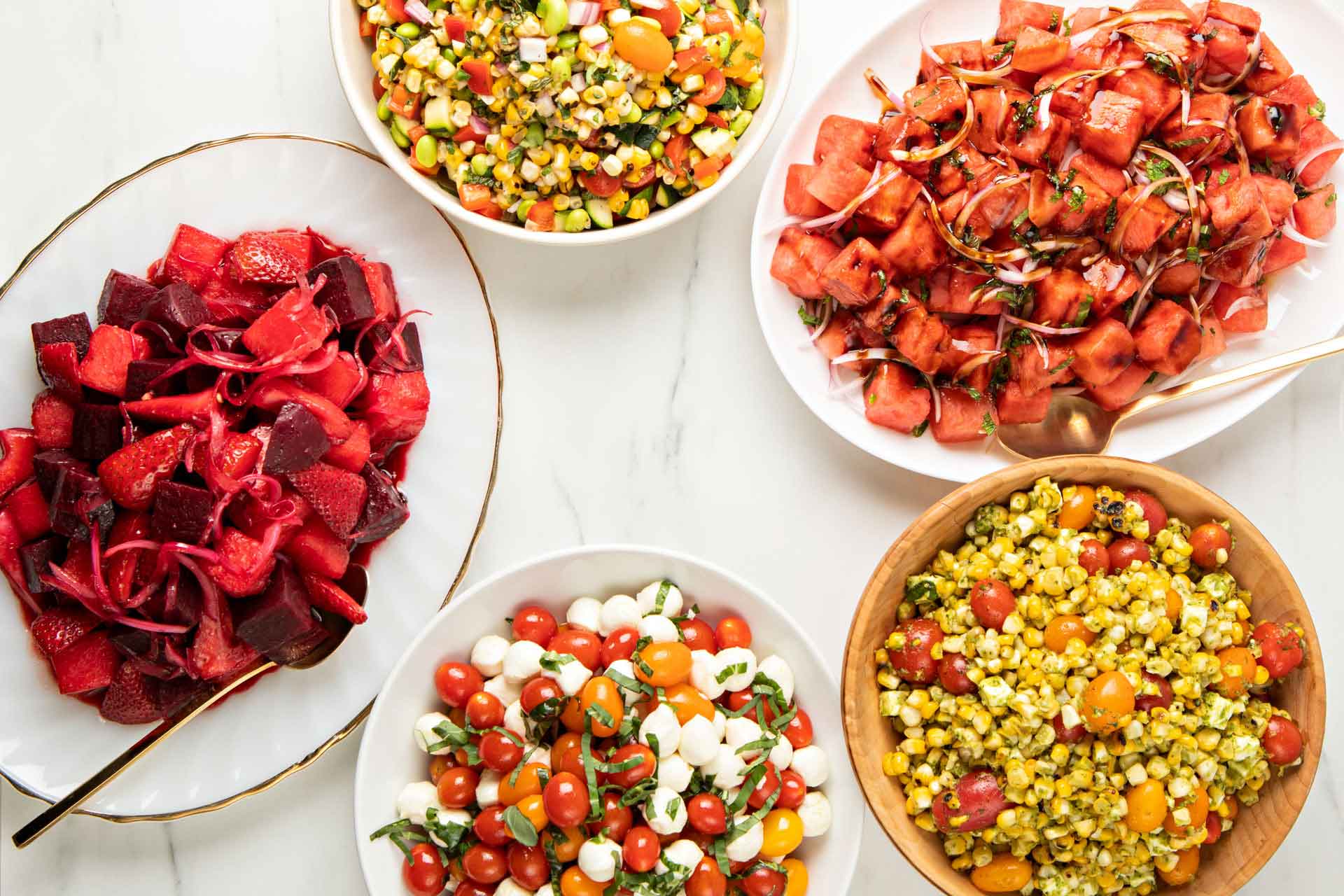 Strawberry beet, corn, caprese, and watermelon mint salads